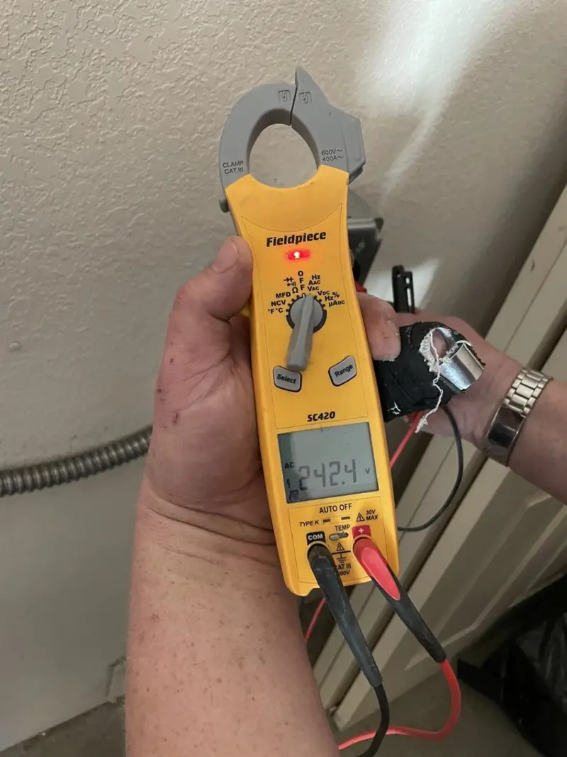 Voltage testing with clamp meter during Outlet Installation in Oviedo